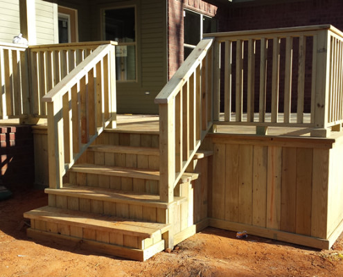 Wood decks add additional outdoor living space to a new custom built home.