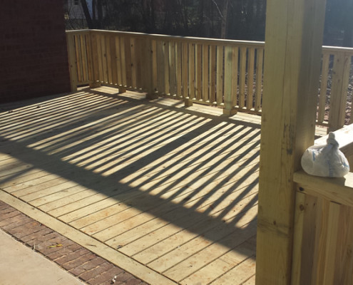 Wood decks add additional outdoor living space to a new custom built home.